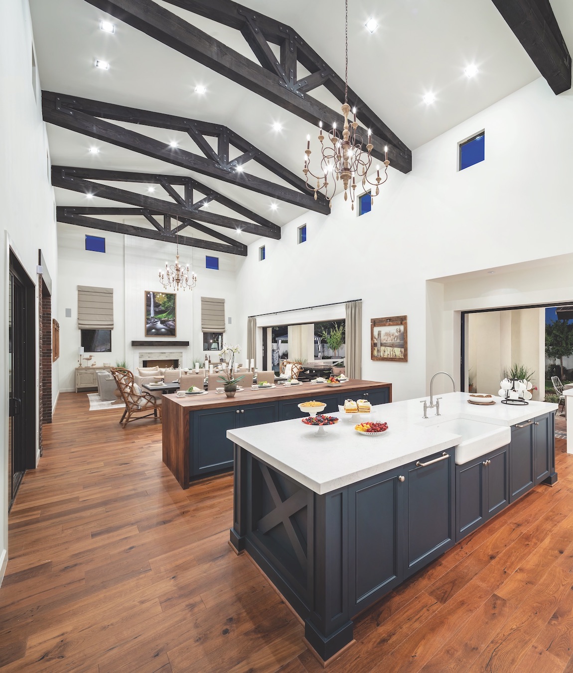 Expansive open floor layout featuring barn ceiling design