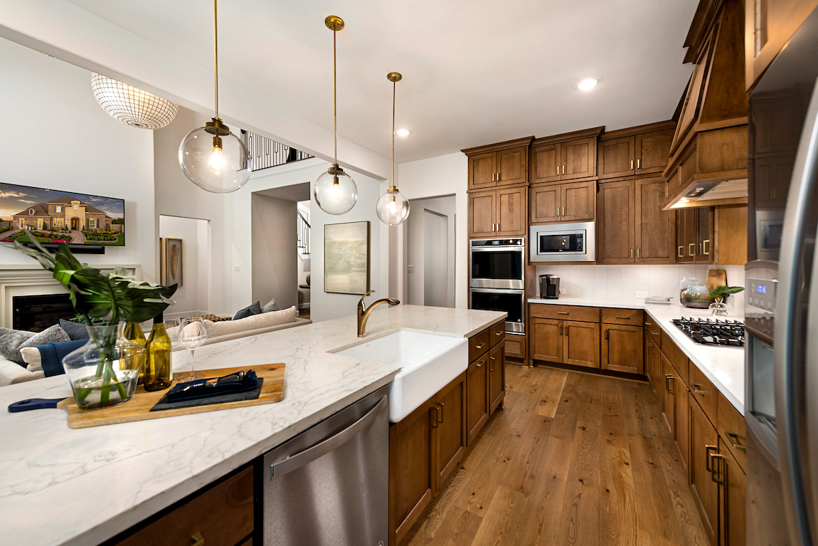 Kitchen with white countertops and wooden cabinets.