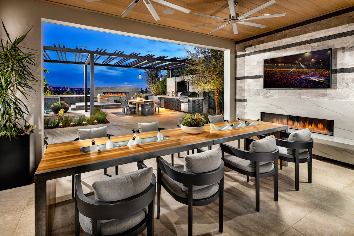 Luxe outdoor room design with fireplace and TV
