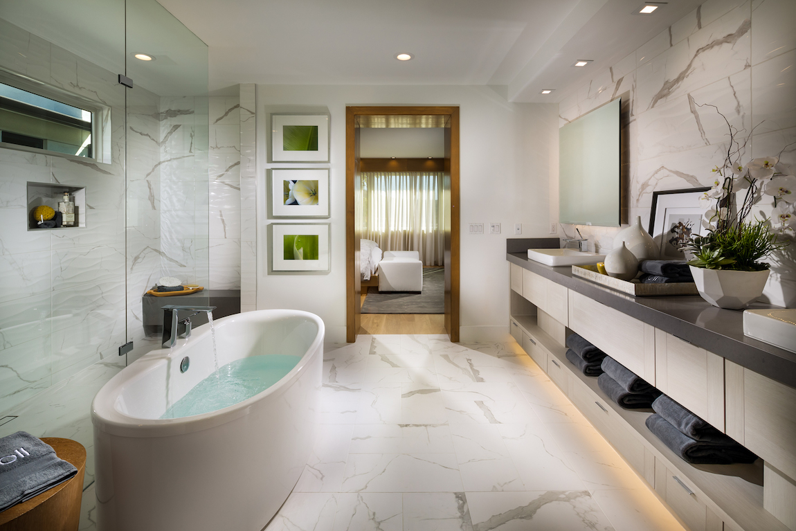 Luxe bathroom design with freestanding bath, walk-in shower, and vanity with accent lighting