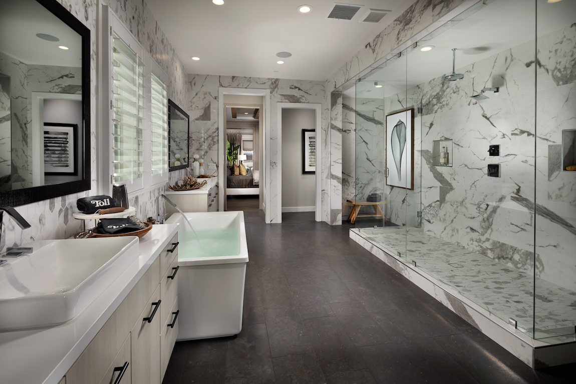 Luxe bathroom with two vanities and walk-in shower