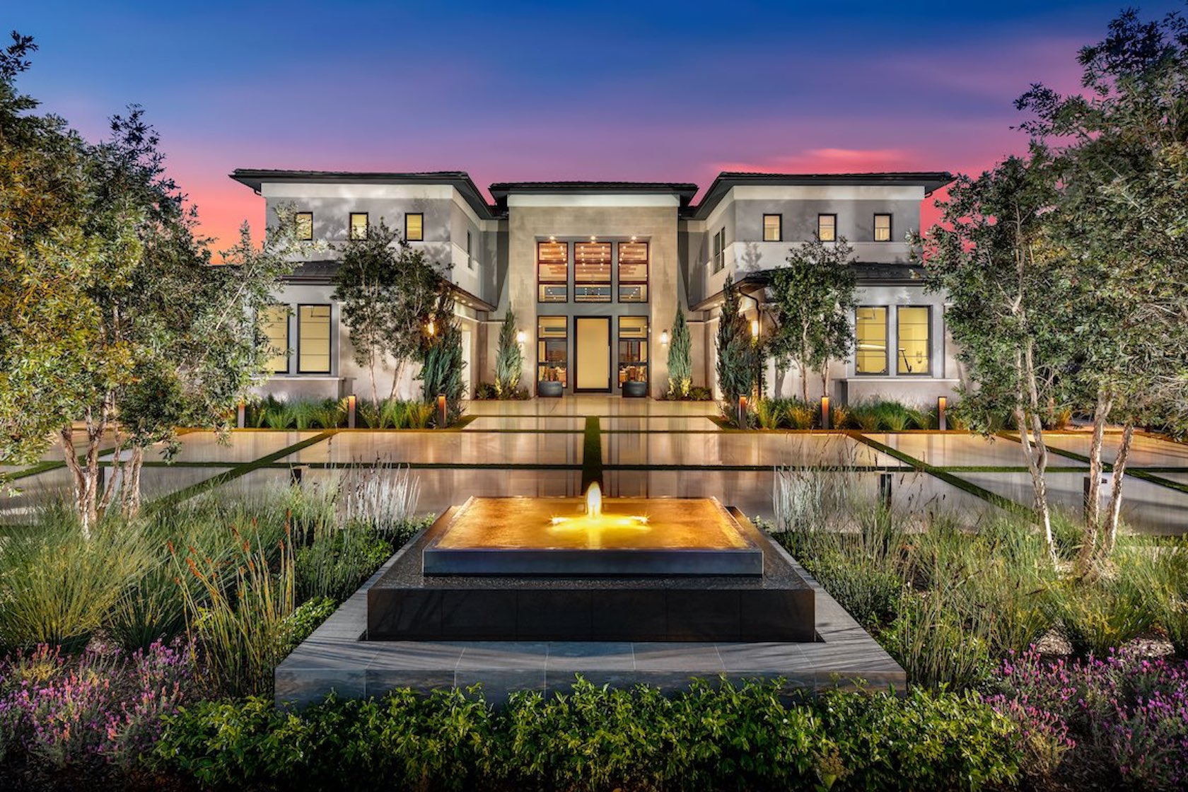 Exterior of luxury home with water fountain.