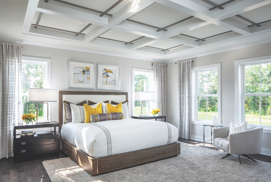 Master bedroom highlighted by yellow accents and wood undertones