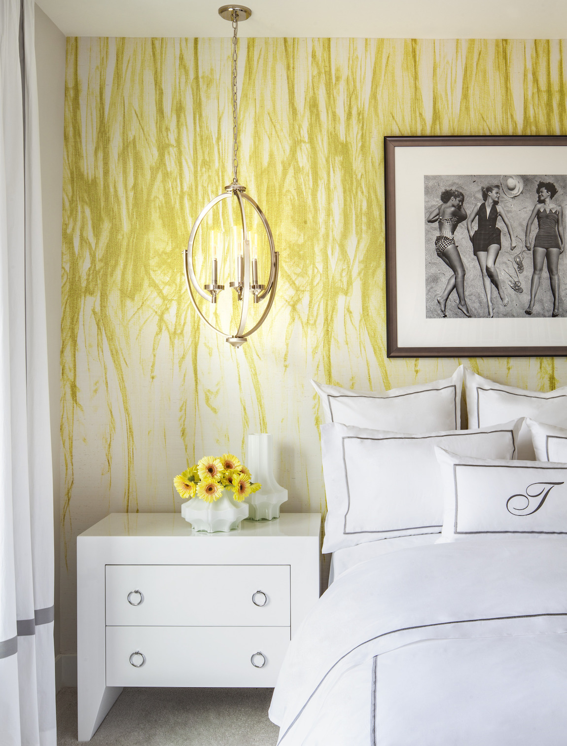 Bedroom featuring bold yellow walls and flowers that accentuate color scheme