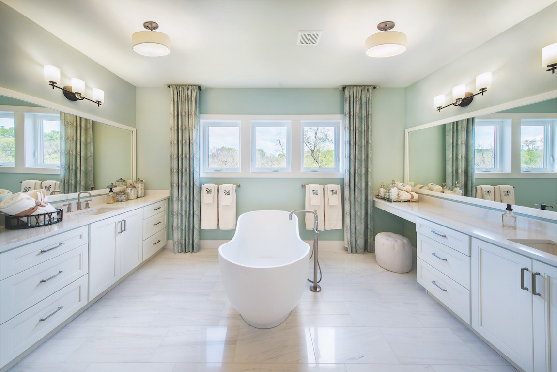 Spacious master bathroom with two vanities and freestanding bath