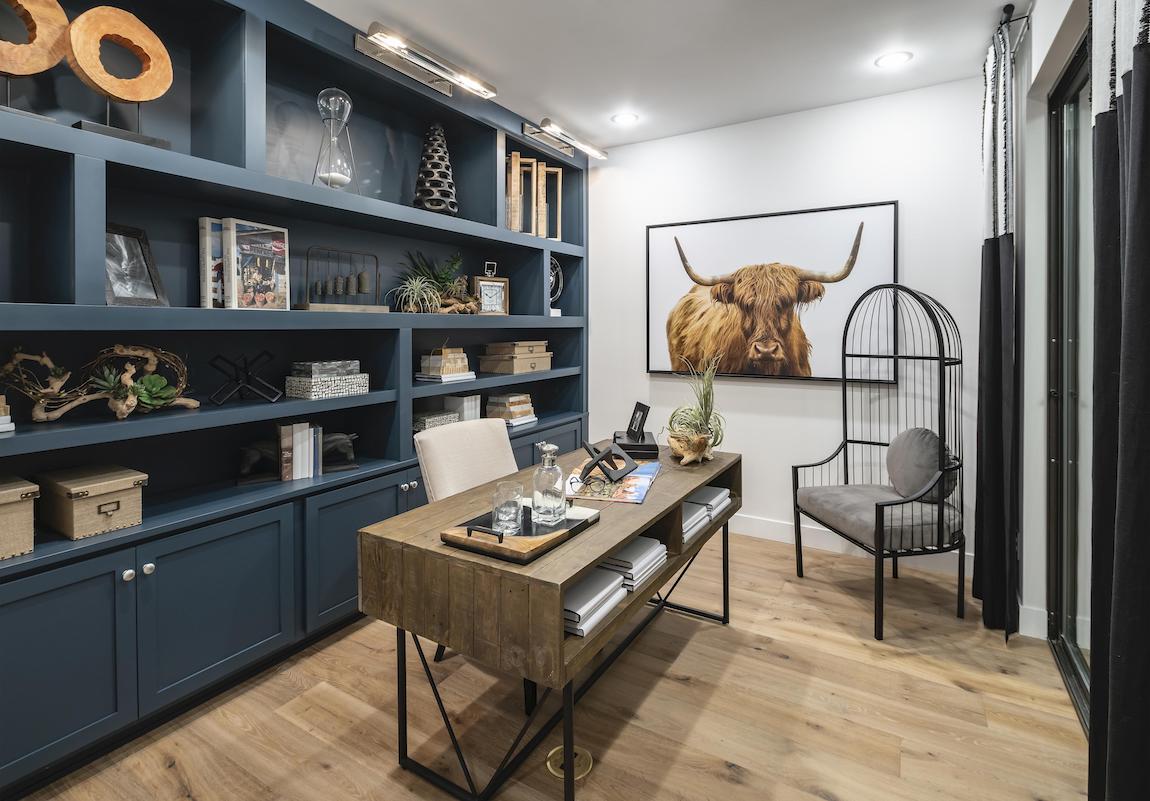 Home office featuring built-in shelving with mementos and keepsakes