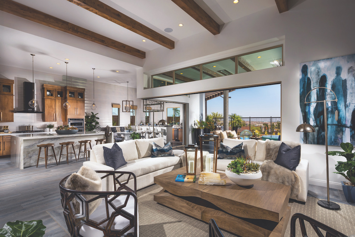 Great room featuring beam ceiling and transition to outdoor living spaces