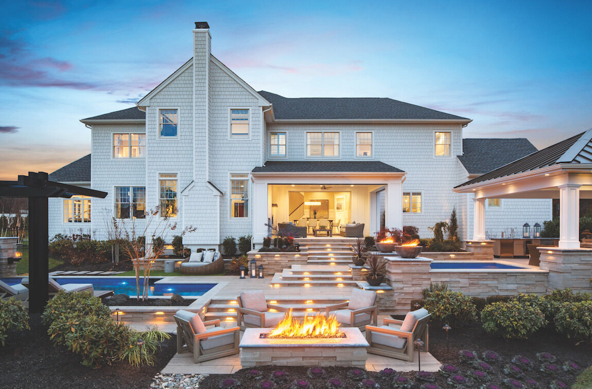 Extensive outdoor backyard with fire pit, pool and landscaping.