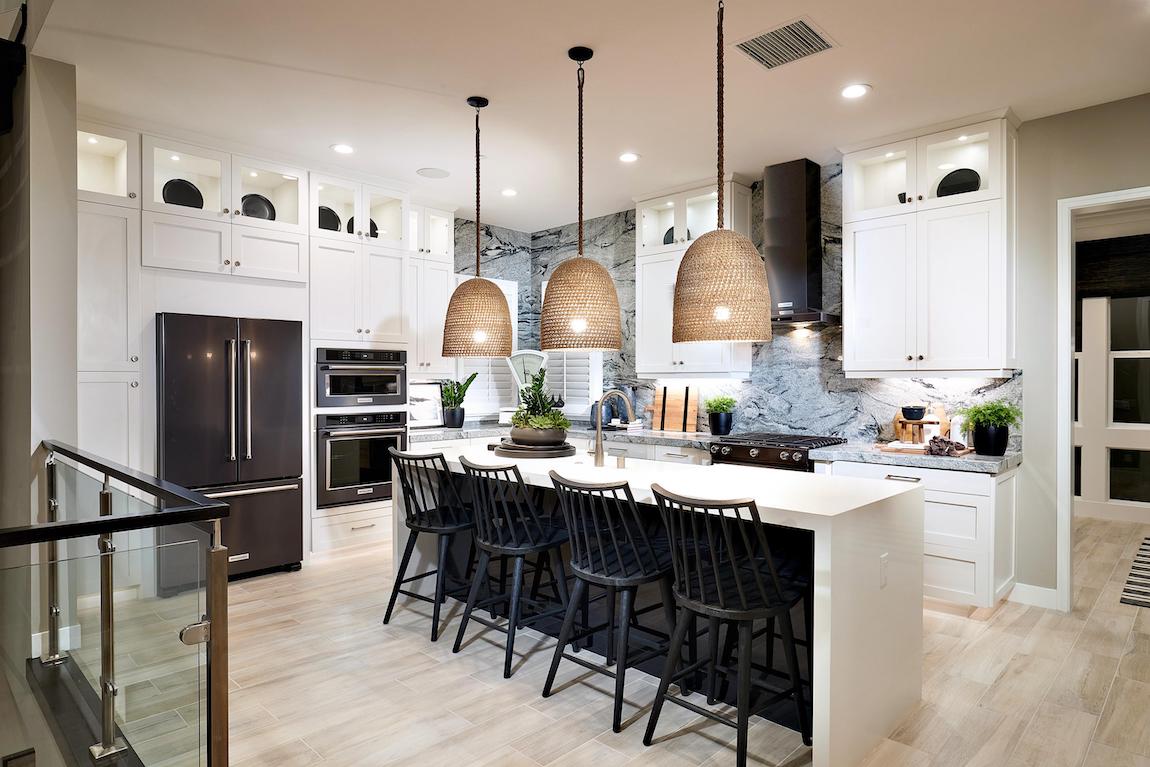 Modern kitchen with waterfall island and prominent pendant lighting