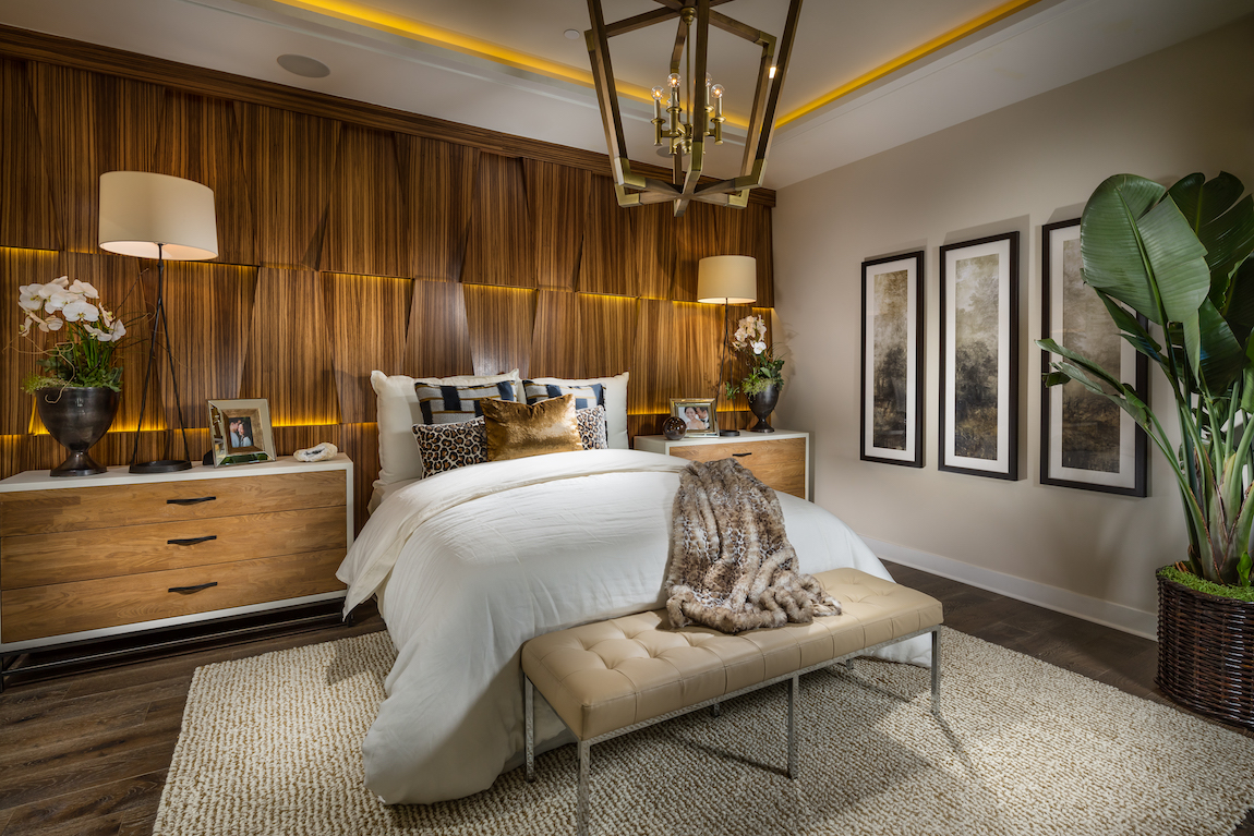 Luxe bedroom with accent lighting, accent wall, and interior plants
