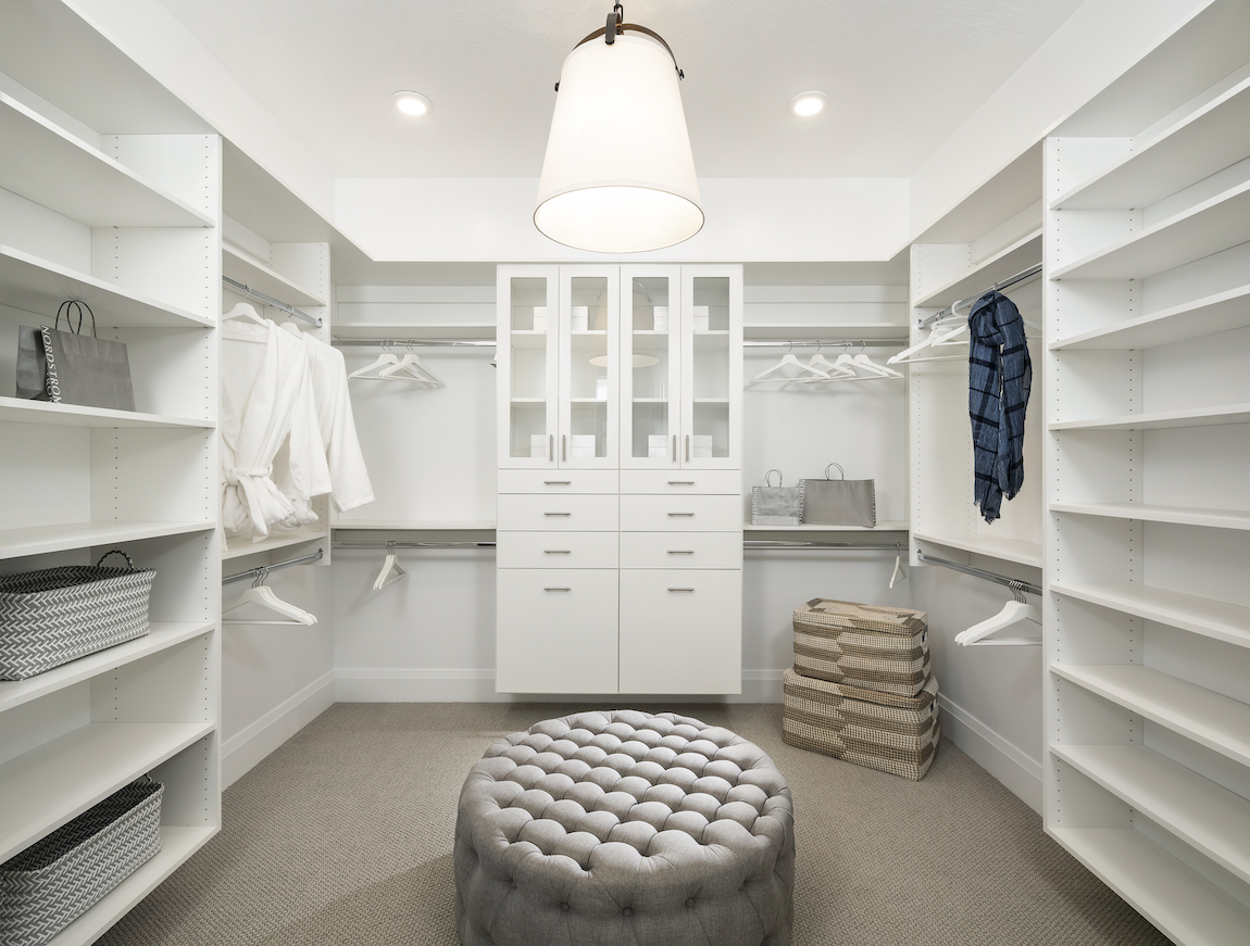 Walk-in closet with built-ins and chaise.