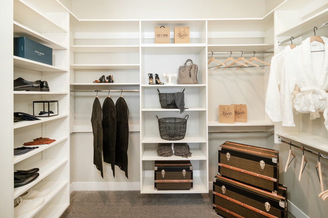 Large walk-in closet with built-in shelving.