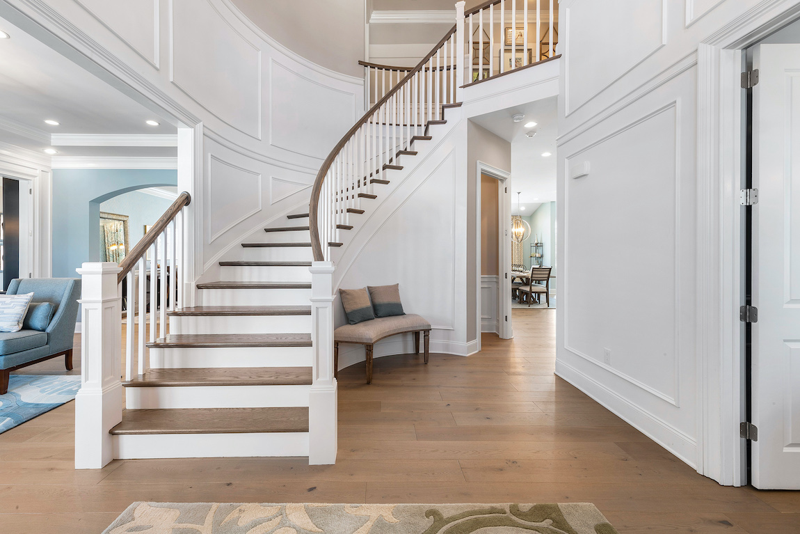 Grand staircase with curve and hard wood floors