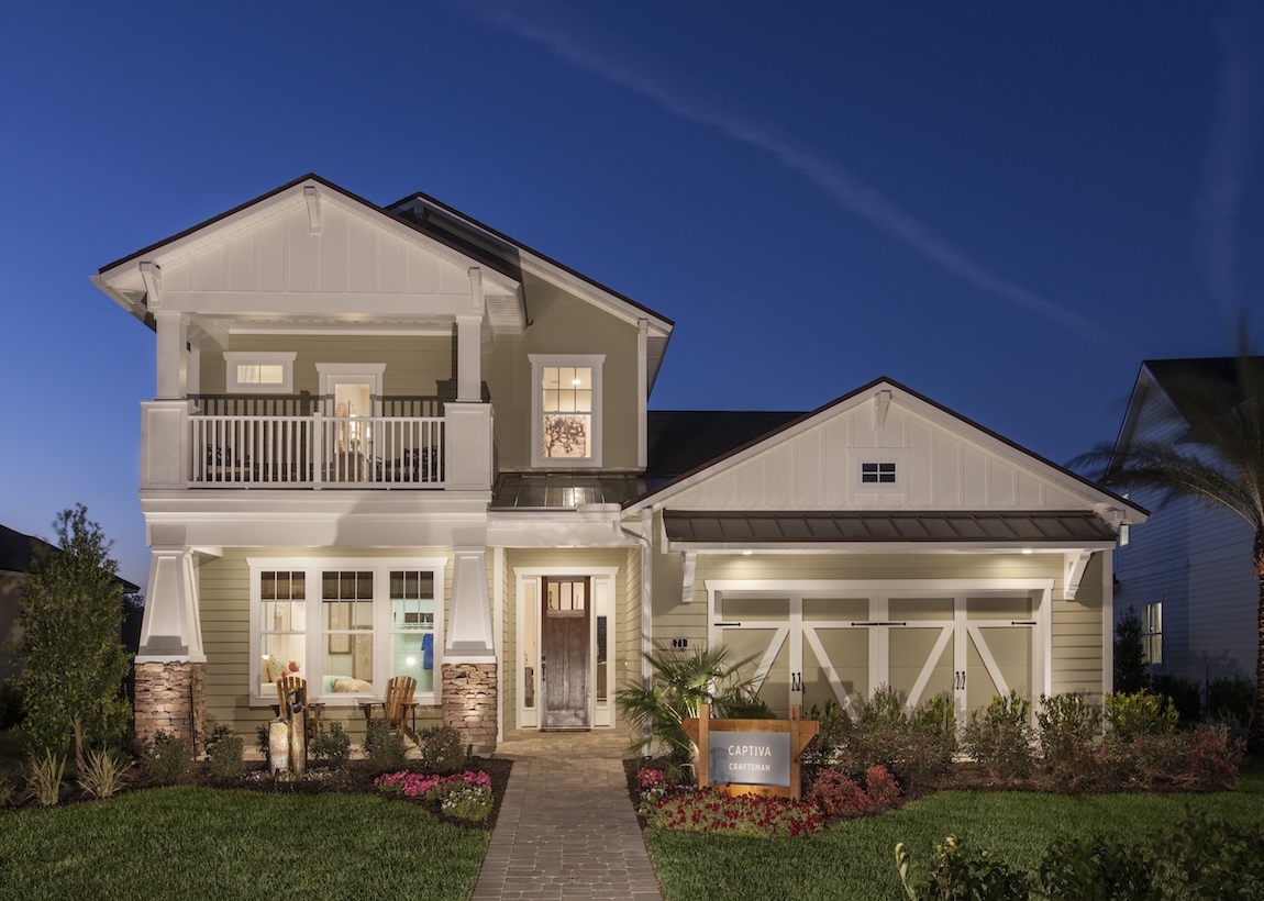 Exterior of a Toll Brothers Captiva model in Florida lit up at dusk.