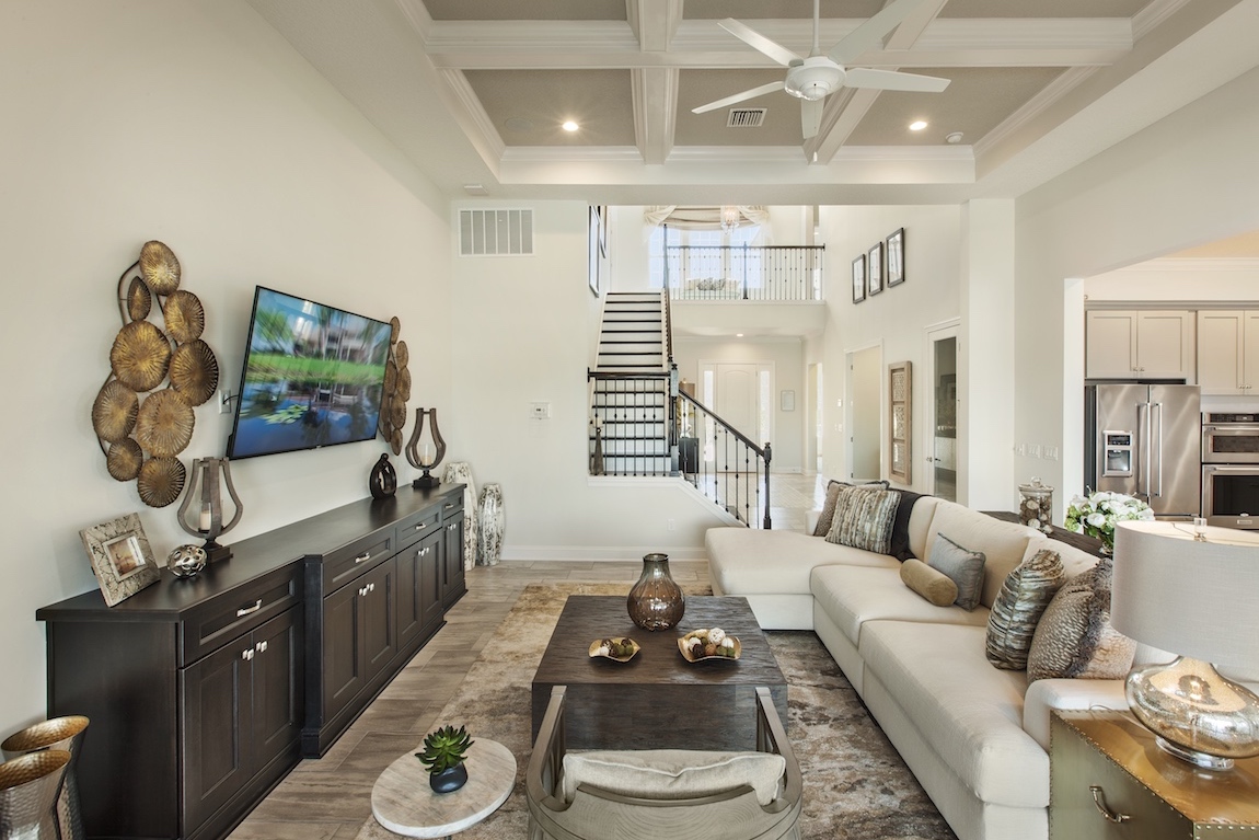 Living room with staircase in a Toll Brothers Julington model home in Florida.