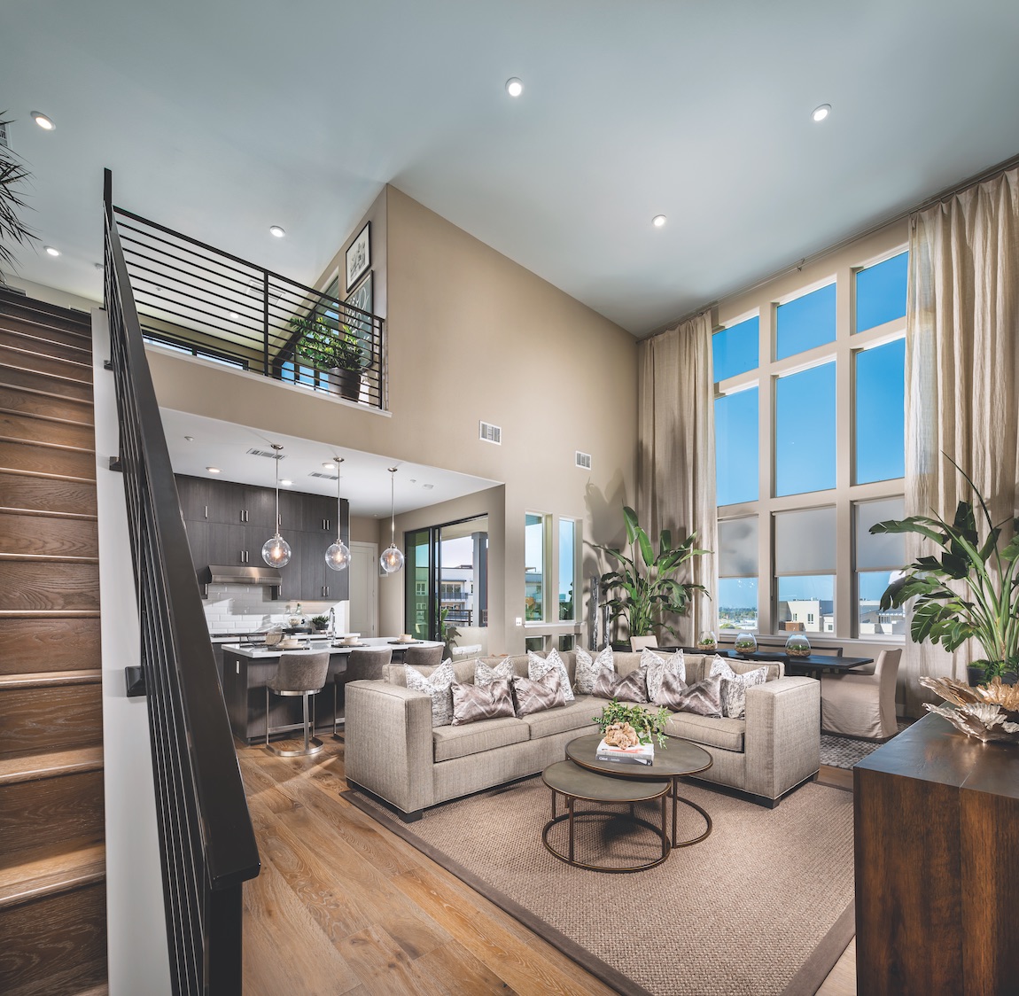 Interior of Metro Crossing home design with floor to ceiling windows, natural light, high hats and tan painted walls.