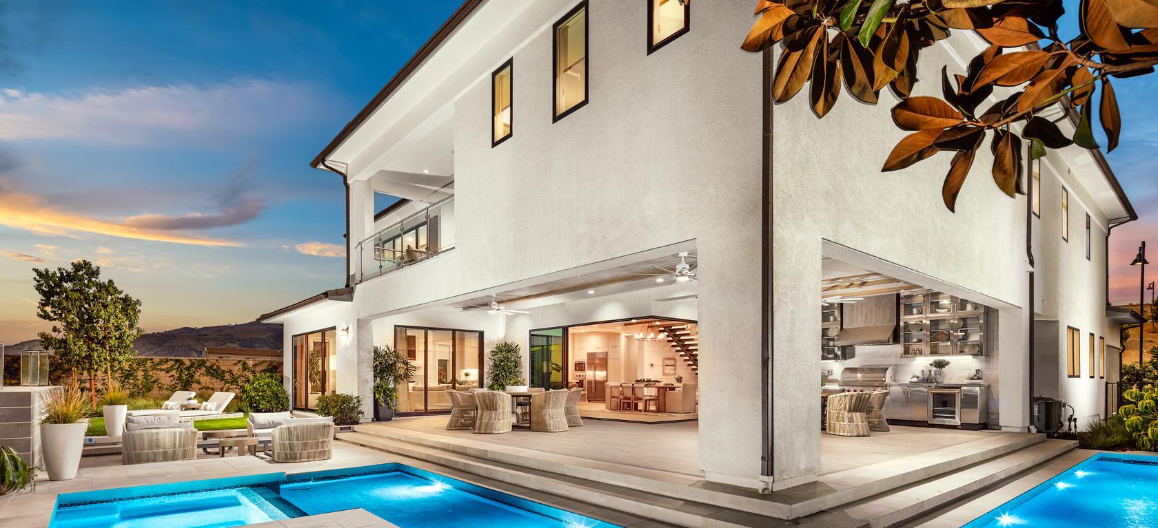 Modern, tan home with luxury surrounding pool and hot tub in Porter Ranch, California