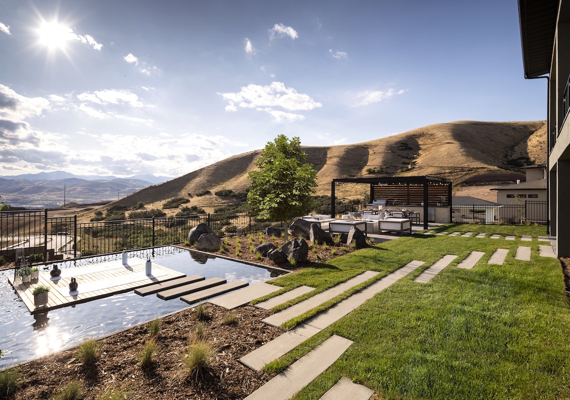 Backyard and pool with a mountain view in a Toll Brothers model home in Canyon Point at Traverse Mountain community.