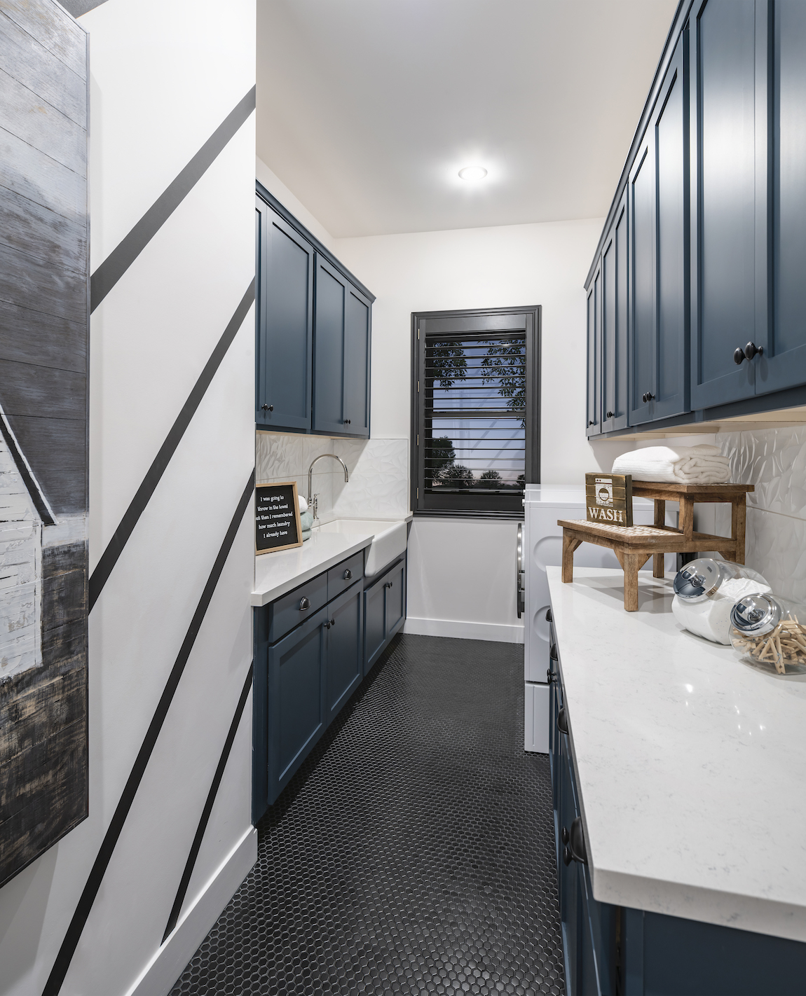 Splendid laundry room with rich blue accent cabinetry
