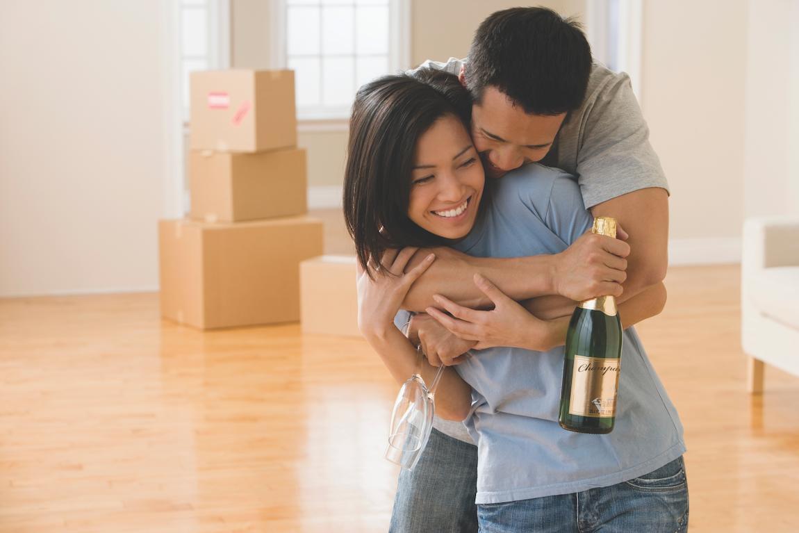 Couple celebrating the completion of cleaning their old home as a part of their moving checklist