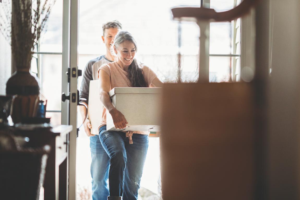 Couple moving into new home with boxes