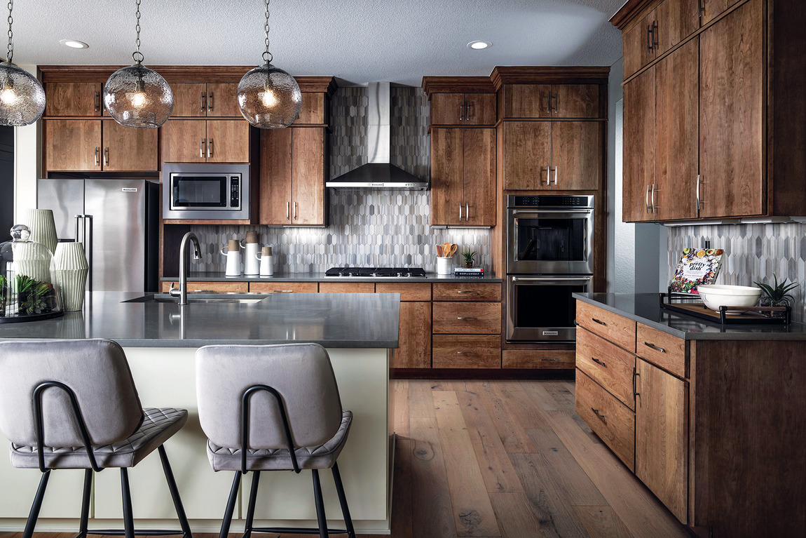 Amazing kitchen featuring spacious island, flat panel cabinetry, and sophisticated backsplash pattern