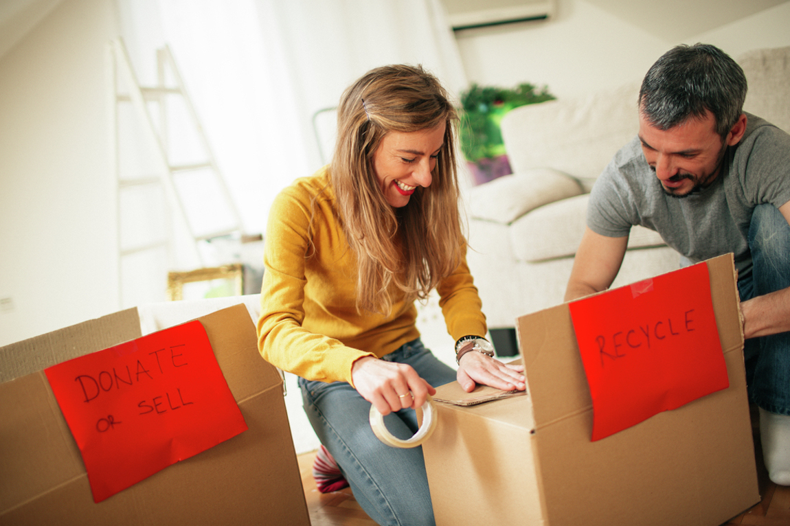 Couple packing moving boxes