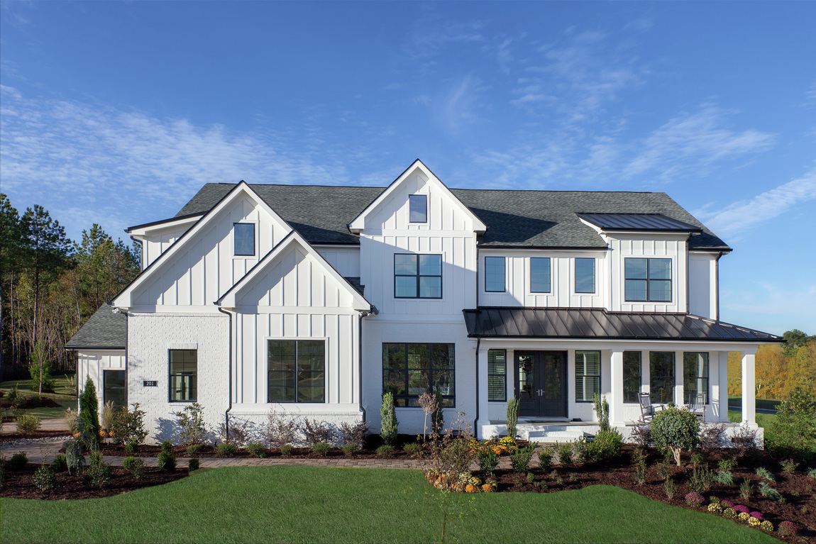 Modern farmhouse with a white on white color scheme and painted brick.