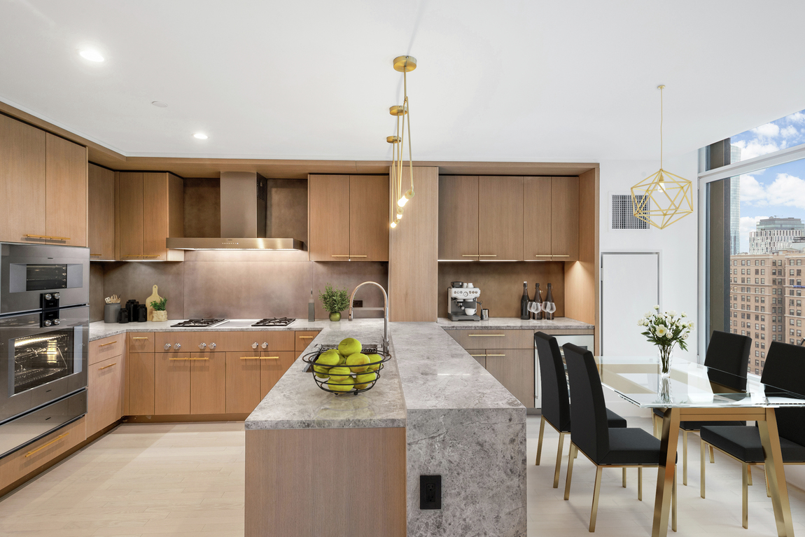 Kitchen in luxury condo with grey quartz countertops