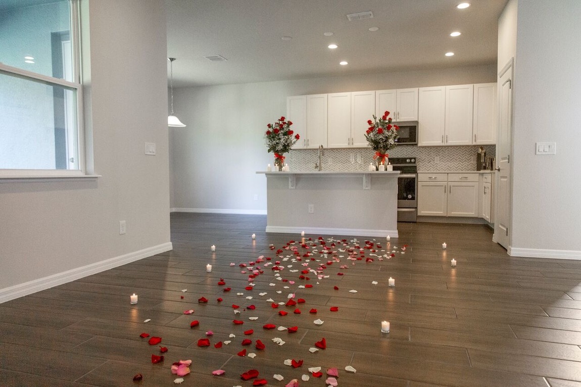 Flowers and candles spread out for the engagement