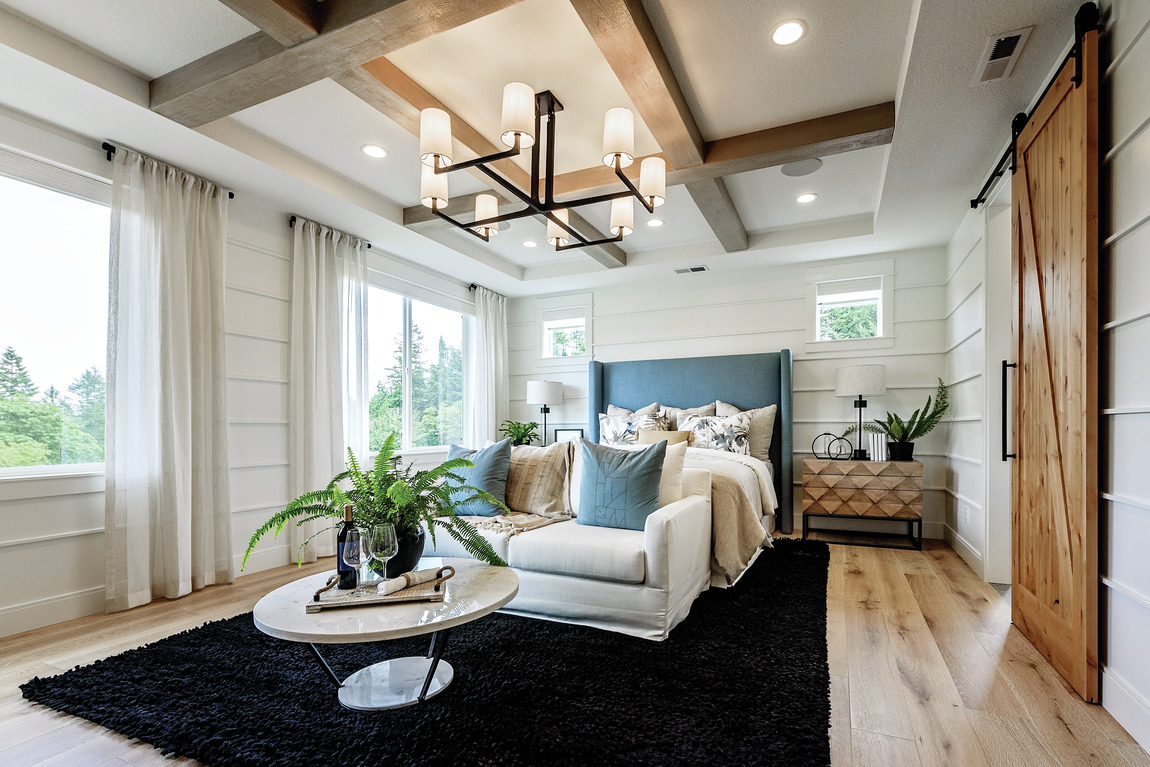 Spacious master bedroom with accent ceiling and energy-efficient lighting