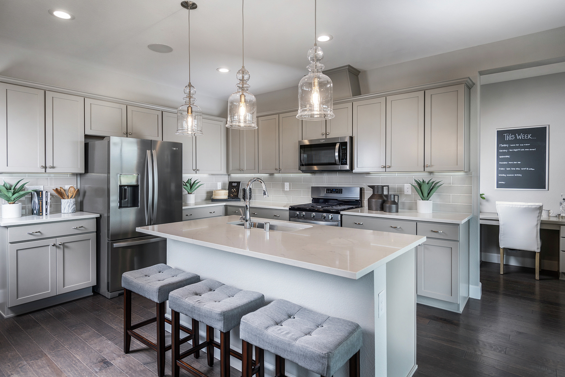 Ivory quartz island countertop in modern kitchen