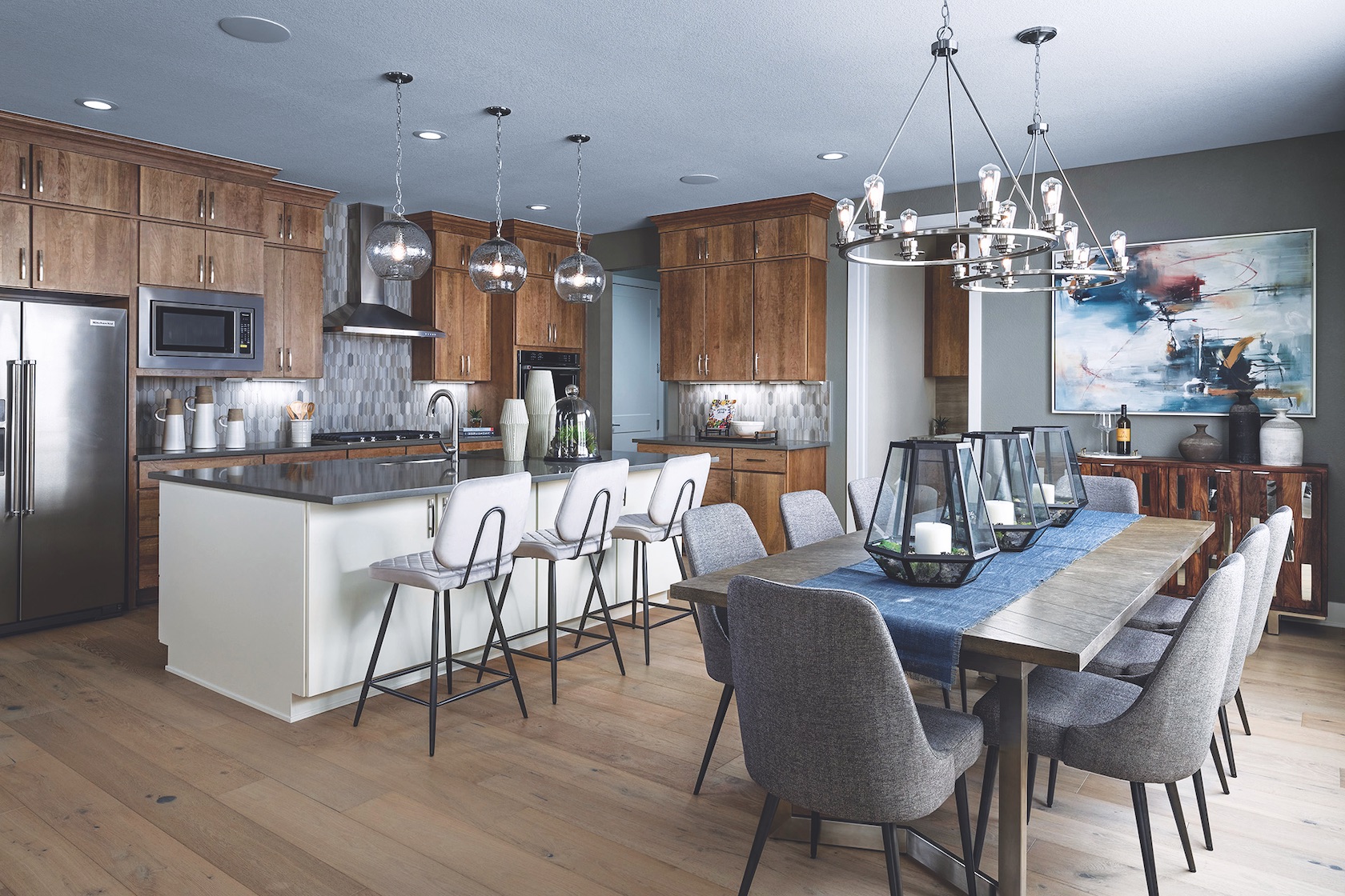 Kitchen with wood cabinets, dining table and pendant fixtures