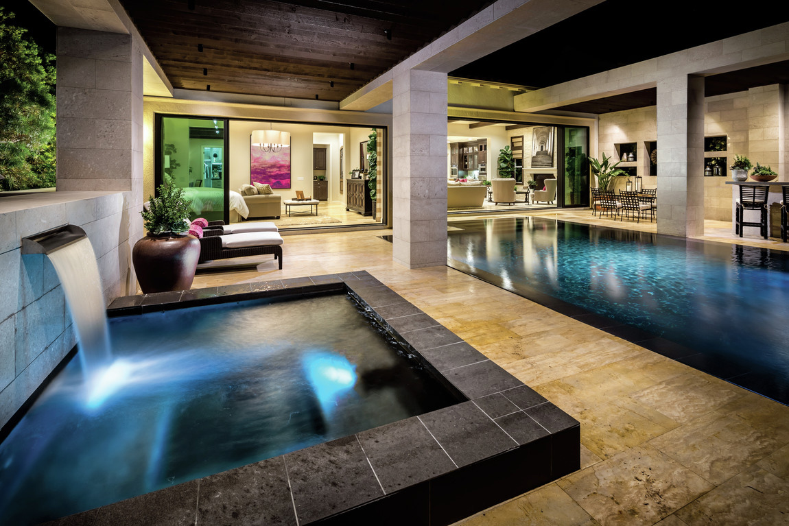 Luxe hot tub and pool in modern backyard design
