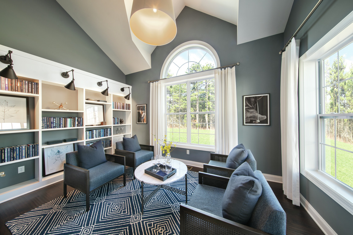 Serene home library with ample natural lighting and windows