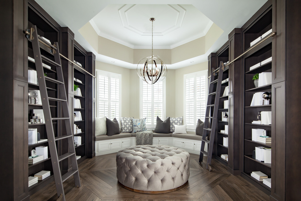 Sophisticated home library with dark cabinetry 