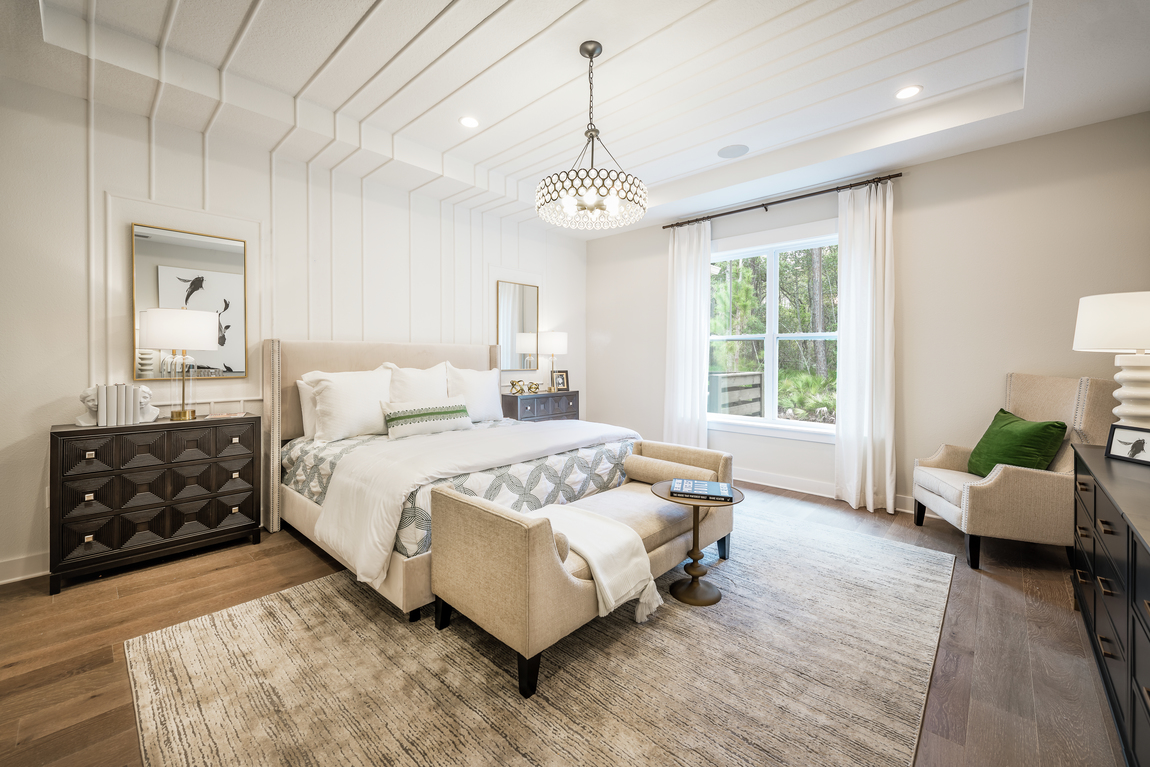 Bedroom with pattern wood accent in ceiling and wall