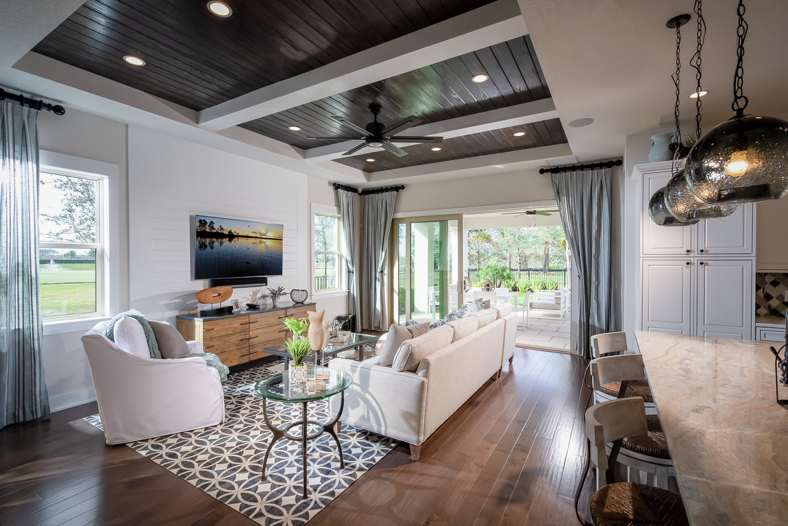 Family room with wooden floors and ceiling accent with outdoor living area