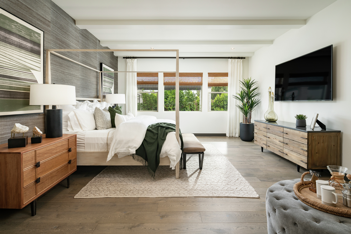 bedroom with contemporary wooden chest of drawers and grey pattered accent wall