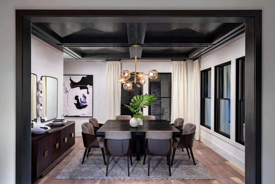 Dining room with black ceiling and hanging lighting fixture