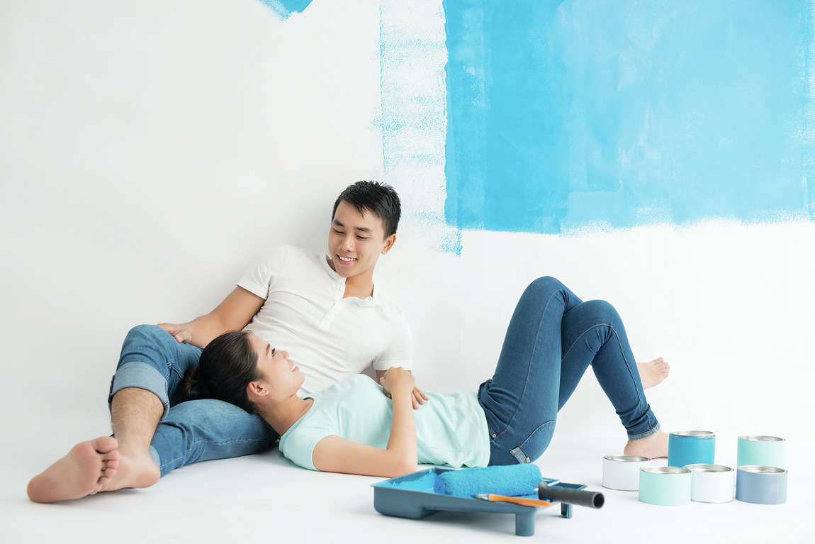 Couple painting wall