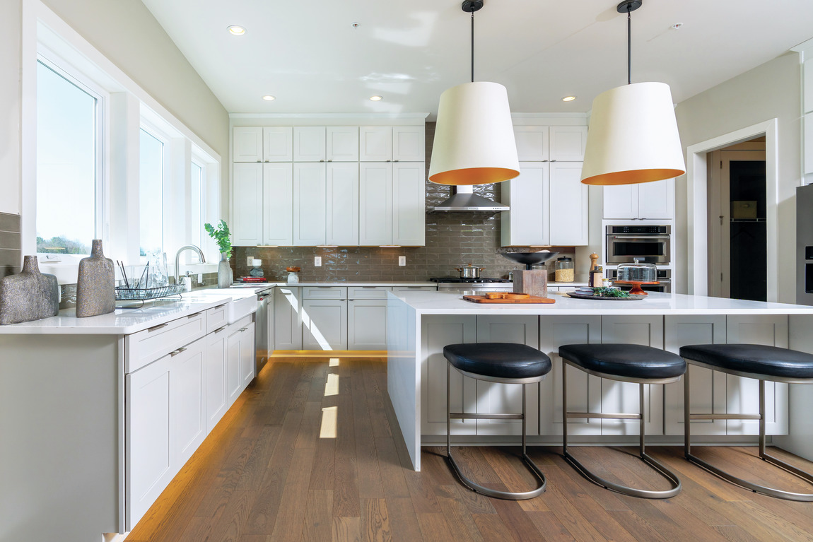 Kitchen implementing design trend such as accent cabinetry lighting