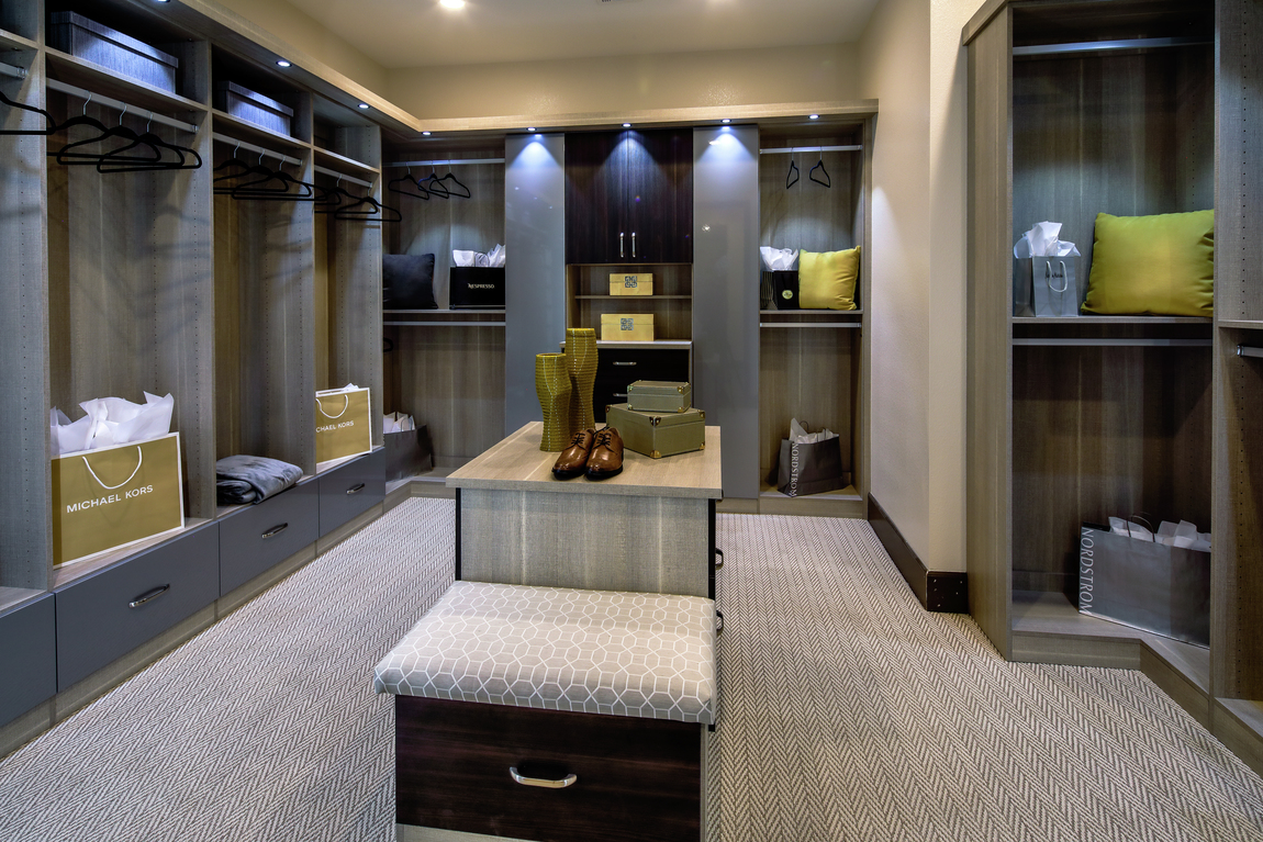 Luxury closet with spotlights, center island and built-in hanging space