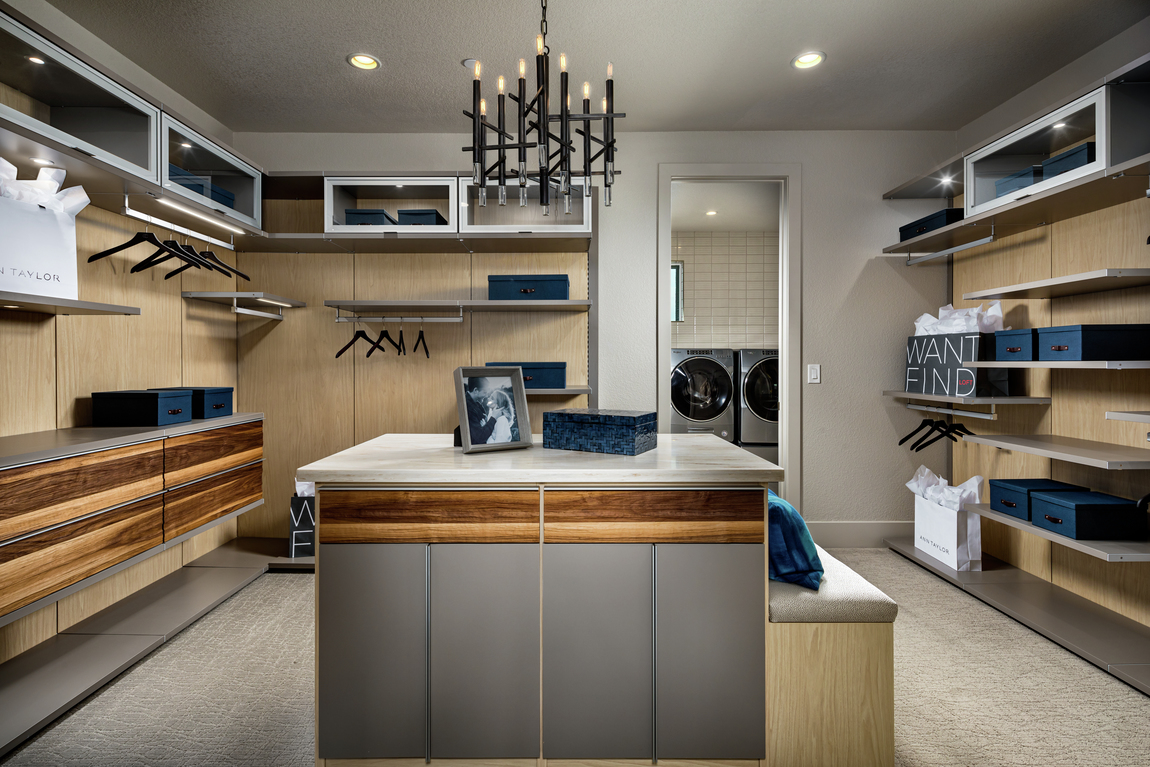 Mid-century modern transitional closet design connecting to laundry room with wood back