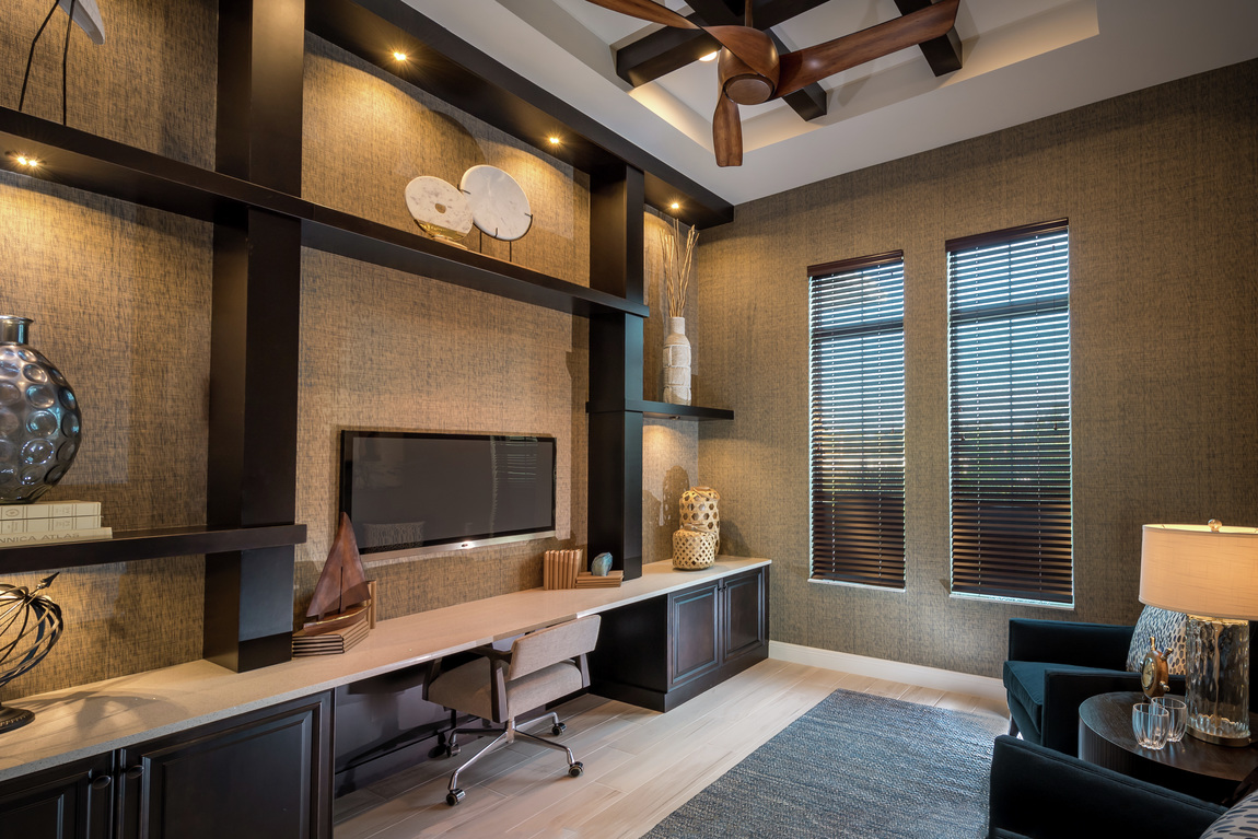 Twisted wooden ceiling fan in office space with dark hues