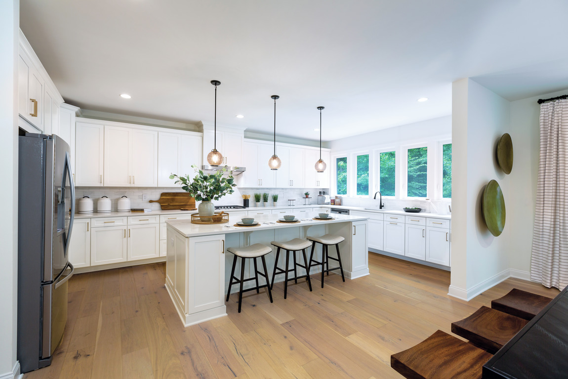 Large modern kitchen with copious natural lighting and lighting fixtures