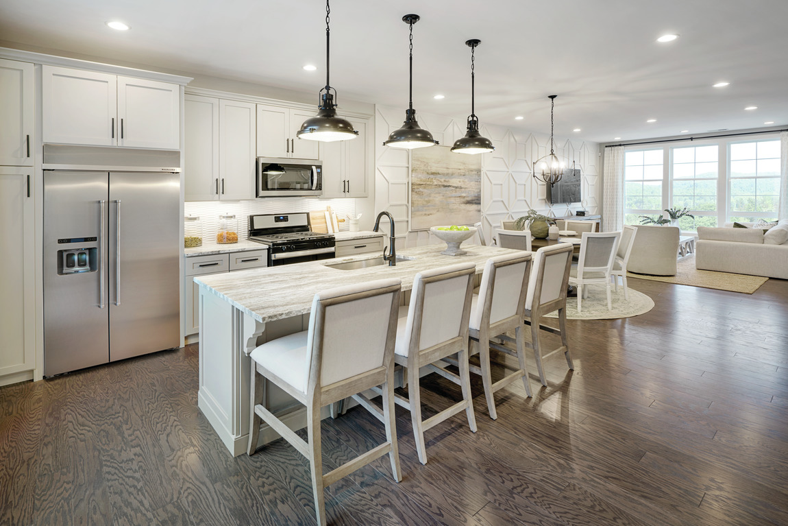 A transitional kitchen with four large barstools to match the center island.