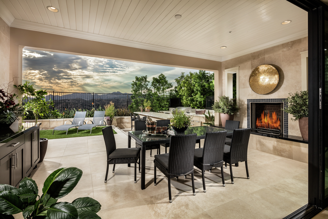 patio with fireplace and table