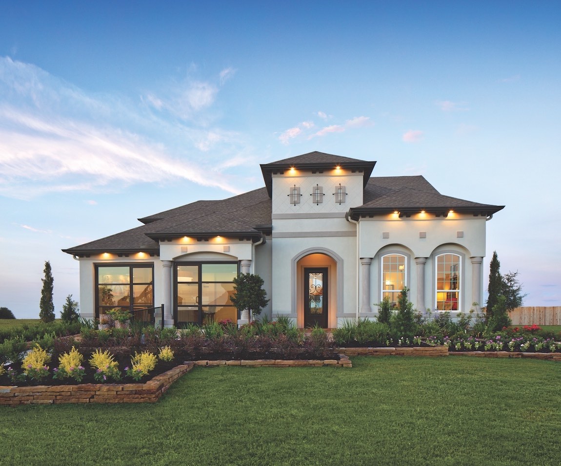 A luxury home in Texas with lighting in the gables.