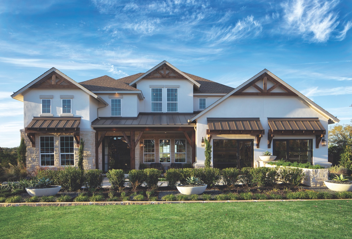 A stone and stucco home with painted metal roofs.